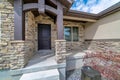 Portico and porch at the entrance of a house with stone brick exterior wall Royalty Free Stock Photo