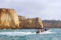 Portimao, Portugal - 10-29-22 - Tourists exploring the Benagil Caves by boat on the Algarve coast