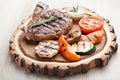 Portion of BBQ t-bone steak with sauce and grilled vegetables Royalty Free Stock Photo