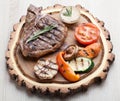 Portion of BBQ t-bone steak with sauce and grilled vegetables Royalty Free Stock Photo