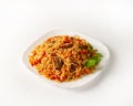 Portion of beef pilaf, decorated with parsley on white background Royalty Free Stock Photo