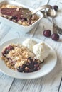 Portion of berry crumble with ice cream