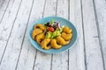 Portion of breaded and fried gabardine prawns with a simple salad of lettuce