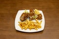 Portion of broaster fried chicken pieces with some salad and chips served