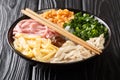 Portion of Bun Thang noodle soup with chicken, ham, shrimps, egg and herbs close-up in a bowl. horizontal Royalty Free Stock Photo