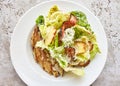 Portion of cesar salad with chicken