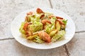 Portion of cesar salad with grilled prawns