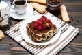 Portion of Classic tiramisu dessert with raspberries, cup of espresso and coffee maker on wooden background Royalty Free Stock Photo