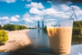 Portion of cold ice cream in a plastic cup on the background of the beach