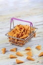 Portion of cone shaped snack tornado shaped crackers. Yellow spicy potato cone chips texture or Background of corn cone