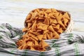 Portion of cone shaped snack tornado shaped crackers. Yellow spicy potato cone chips texture or Background of corn cone