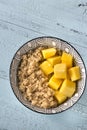 Portion of cooked quinoa with mango slices Royalty Free Stock Photo