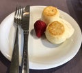 Portion of cottage cheese pancakes with citron orange zest on white porcelain plate. Royalty Free Stock Photo