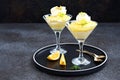 Portion creamy dessert with lemon curd, mascarpone cream and biscuit, garnished with whipped cream and crushed pistachios, in