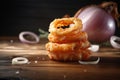 portion of crispy fried onion rings on rustic wooden table. AI generated