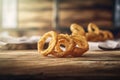 portion of crispy fried onion rings on rustic wooden table. AI generated