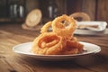 portion of crispy fried onion rings on rustic wooden table. AI generated