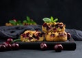 Portion crumble pie with cherries on a wooden board decorated with green mint leaves