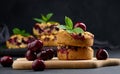 Portion crumble pie with cherries on a wooden board decorated with green mint leaves