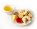 Portion of the Dagestan khinkal in Avar style on a plate with tomato sauce and a cup of broth