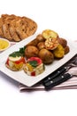 Portion of delicious chicken aspic and baked potato on a plate isolated on white background Royalty Free Stock Photo