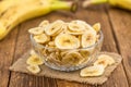 Portion of Dried Banana Chips on wooden background, selective focus Royalty Free Stock Photo