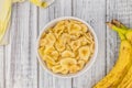 Portion of Dried Banana Chips on wooden background, selective focus Royalty Free Stock Photo