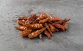 Portion of dried Vietnamese chili peppers on a gray background side view