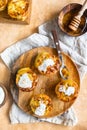 Portion Dutch baby pancakes with apples served with cream, honey and cinnamon on wooden plate. Delicious sweet breakfast Royalty Free Stock Photo