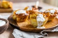 Portion Dutch baby pancakes with apples served with cream, honey and cinnamon on wooden plate. Delicious sweet breakfast Royalty Free Stock Photo