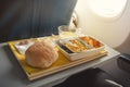 Portion of food for one passenger in cardboard box at airplane board. Royalty Free Stock Photo