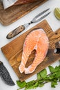 Portion of fresh salmon fillet, on white stone table background, top view flat lay