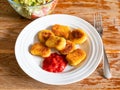 Portion of fried Chicken nuggets on wooden table