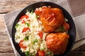 Portion of fried chicken thighs with garnish of rice with vegetables close-up. Horizontal top view from above Royalty Free Stock Photo