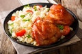 Portion of fried chicken thighs with garnish of rice with vegetables close-up. horizontal Royalty Free Stock Photo