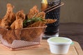 portion of fried fish, fried chicken strips inside metal basket tasty snack