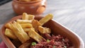 A portion of fried maniocs Mandiocas on a wooden table, traditional brazilian food