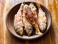 Portion of fried red mullet fish on ceramic plate Royalty Free Stock Photo