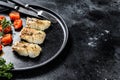 A portion of Grilled, baked pollock or coalfish fillets. Black background. Top view. Copy space