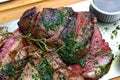 Portion of grilled beef chateaubriand with herbs