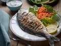 Grilled fish on wooden kitchen table Royalty Free Stock Photo