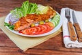 Portion of grilled trout fillet with vegetables on rustic table