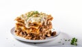 Portion of ground beef lasagna topped with melted cheese and garnished with fresh parsley, isolated on a white background