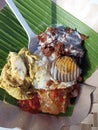 A portion of gudeg rice on plate cover with banana leaf. A traditional food from Central Java, Indonesia with white rice.