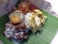 A portion of gudeg rice on plate cover with banana leaf. A traditional food from Central Java, Indonesia with white rice.