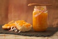 Portion of hollow bread with homemade orange marmalade and a rustic background Royalty Free Stock Photo