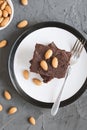 Portion of homemade chocolate brownie cake with almond nuts