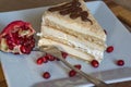 Portion homemade cream cake with pomegranate seeds and chocolate spread