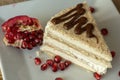 Portion homemade cream cake with pomegranate seeds and chocolate spread