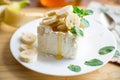 Portion of homemade milk curd with banana slices and honey